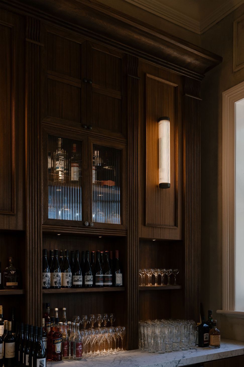 Glass-fronted cabinets behind the bar