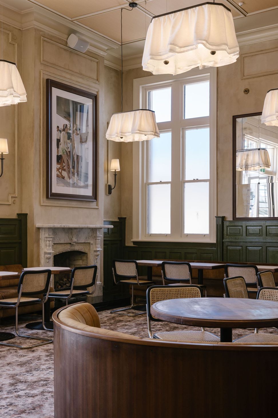 The Hotel Ponsonby dining room, with a curved booth beneath tall windows