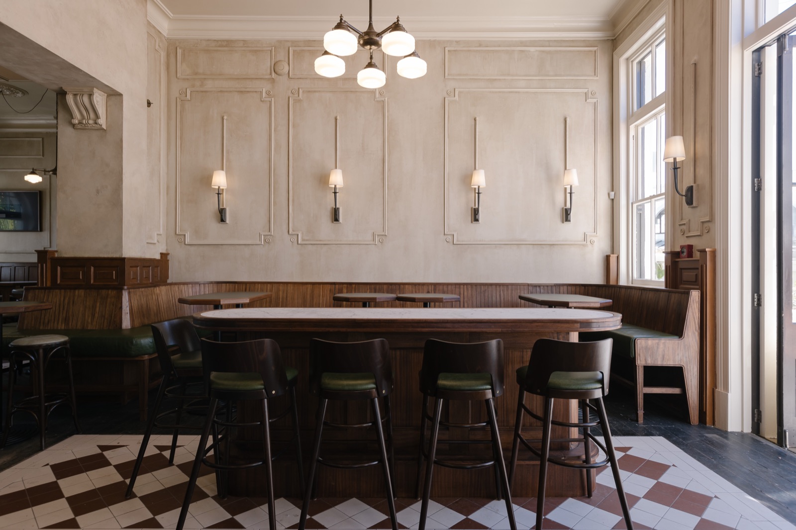 Bar leaners and stools on the chequered tile floor
