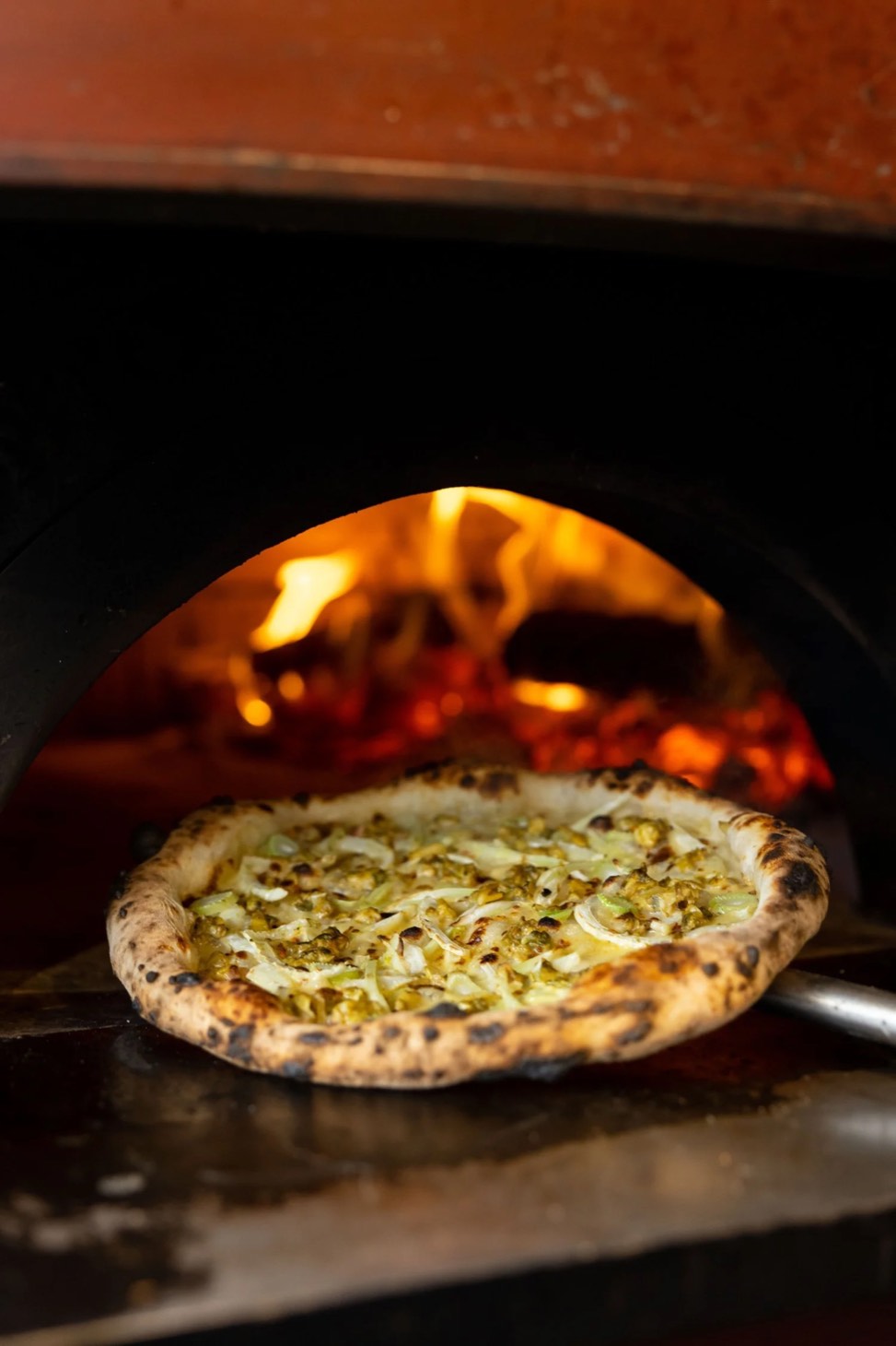 A pizza in the wood-fired oven