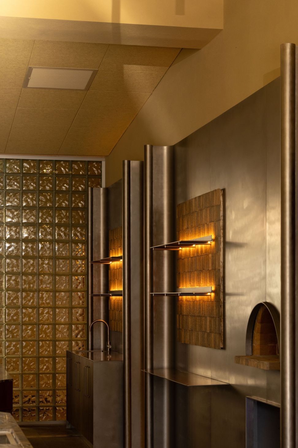 Glass brick, steel and wall lights at Mother